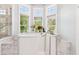 Luxurious bathroom with a walk-in tub, marble accents, and natural light at 317 Red Gate Overlook, Canton, GA 30115
