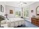 Cozy bedroom with a decorative quilt, large windows, and an antique dresser at 317 Red Gate Overlook, Canton, GA 30115