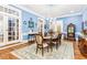 Traditional dining room with chandelier, blue walls, wood floor, area rug and access to the outside at 317 Red Gate Overlook, Canton, GA 30115