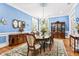 Dining room with china cabinet, hardwood floors, chandelier, and elegant decor with a large window at 317 Red Gate Overlook, Canton, GA 30115
