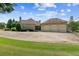 Spacious home exterior featuring a three-car garage and a large driveway, set on a lush, green lawn at 317 Red Gate Overlook, Canton, GA 30115