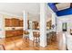 Open concept kitchen with breakfast bar, dark wooden cabinets, hardwood floors, and view to Gathering room at 317 Red Gate Overlook, Canton, GA 30115