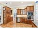 Kitchen with wooden cabinets, stainless appliances, granite counters, and hardwood floors at 317 Red Gate Overlook, Canton, GA 30115