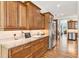 Kitchen with wooden cabinetry, granite countertops and stainless-steel appliances at 317 Red Gate Overlook, Canton, GA 30115