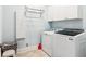 Functional laundry room with white cabinets and modern washer and dryer at 317 Red Gate Overlook, Canton, GA 30115