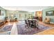 Large living room with hardwood flooring, ornate rugs, and multiple seating arrangements at 317 Red Gate Overlook, Canton, GA 30115