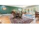 Elegant living area featuring hardwood floors, large windows, and dining tables at 317 Red Gate Overlook, Canton, GA 30115