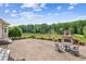 Expansive brick patio with an outdoor fireplace overlooking a serene lake view at 317 Red Gate Overlook, Canton, GA 30115