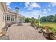 Expansive brick patio with fireplace, outdoor seating, and lake views create an inviting outdoor space at 317 Red Gate Overlook, Canton, GA 30115