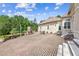 Large brick patio features an outdoor fireplace, ample seating area, and views of the manicured backyard at 317 Red Gate Overlook, Canton, GA 30115