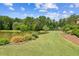 Picturesque pond with lush greenery and landscaping enhances the beauty of this property at 317 Red Gate Overlook, Canton, GA 30115