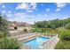 Inviting in-ground pool area with a white fence and lush landscaping, overlooking the tranquil lake at 317 Red Gate Overlook, Canton, GA 30115