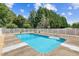 Sparkling in-ground pool surrounded by fencing, offering a refreshing escape on sunny days at 317 Red Gate Overlook, Canton, GA 30115