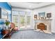 Bedroom sitting area with a fireplace, large windows, and a comfortable chair at 317 Red Gate Overlook, Canton, GA 30115