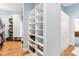 Organized walk-in closet with custom shelving, cabinets, and ample storage space at 317 Red Gate Overlook, Canton, GA 30115