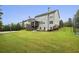 Large backyard with a sport court, patio, and mature trees providing shade at 3705 Williams Point Dr, Cumming, GA 30028