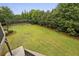 Expansive backyard featuring lush green lawn and a private baseball practice area at 3705 Williams Point Dr, Cumming, GA 30028