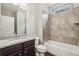 Bathroom features a granite countertop vanity and tile shower over tub at 3705 Williams Point Dr, Cumming, GA 30028