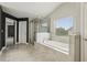 Primary bathroom features a tiled tub and a glass-enclosed shower at 3705 Williams Point Dr, Cumming, GA 30028