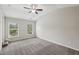 Spacious bedroom with plush carpeting and natural light from large windows at 3705 Williams Point Dr, Cumming, GA 30028