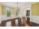 Inviting dining room with hardwood floors, decorative trim, and bright yellow walls at 3705 Williams Point Dr, Cumming, GA 30028