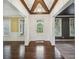 Welcoming entryway with hardwood floors, decorative columns, and exposed beam ceiling at 3705 Williams Point Dr, Cumming, GA 30028