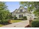 Charming home with a three-car garage, mature landscaping, and inviting curb appeal at 3705 Williams Point Dr, Cumming, GA 30028