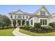 Charming two-story home with a manicured lawn and inviting front porch at 3705 Williams Point Dr, Cumming, GA 30028