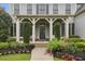 Inviting front porch with manicured shrubs and colorful flowers at 3705 Williams Point Dr, Cumming, GA 30028