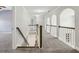 Hallway with decorative arches, carpet flooring, and wood and white railings at 3705 Williams Point Dr, Cumming, GA 30028