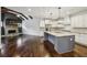Open kitchen leading to a Gathering room, featuring granite counters, a large island, and stainless appliances at 3705 Williams Point Dr, Cumming, GA 30028