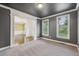 Carpeted living room with gray walls, bright white trim, and an open view of the dining room at 3705 Williams Point Dr, Cumming, GA 30028