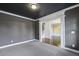 Living room featuring gray walls, white trim, carpet floors, and an open floor plan at 3705 Williams Point Dr, Cumming, GA 30028