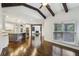 Open-concept living room with wood floors and views of the gourmet kitchen at 3705 Williams Point Dr, Cumming, GA 30028