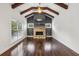 Cozy living room featuring a stone fireplace, wood beam ceiling, and ample natural light at 3705 Williams Point Dr, Cumming, GA 30028