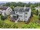 Aerial view of home's rear exterior and extensive yard featuring sports areas and lush landscaping at 3705 Williams Point Dr, Cumming, GA 30028
