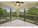 Cozy screened porch with wooden flooring and ceiling fan, perfect for relaxing outdoors at 3705 Williams Point Dr, Cumming, GA 30028