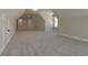 Large bonus room with multiple doors and windows, featuring neutral carpet at 4850 Cool Springs Rd, Winston, GA 30187