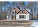 A beautiful two-story home features stone accents, mixed siding, a welcoming front porch, and a neatly manicured lawn at 4850 Cool Springs Rd, Winston, GA 30187