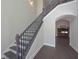 Elegant staircase with dark iron spindles and hardwood steps leads to the upper level, complemented by neutral walls at 4850 Cool Springs Rd, Winston, GA 30187
