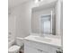 Bathroom featuring a large mirror, white cabinets, and tub at 6934 Melody Ridge Rd, Buford, GA 30518