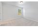 Cozy bedroom with neutral walls, carpet, and natural light from a window at 6934 Melody Ridge Rd, Buford, GA 30518