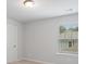 Bright bedroom with neutral carpet, one window, and white trim at 6934 Melody Ridge Rd, Buford, GA 30518