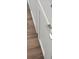 Close up of white kitchen cabinets with silver hardware and wood look flooring at 6934 Melody Ridge Rd, Buford, GA 30518