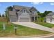 Beautiful two-story home with a three-car garage and well-manicured lawn at 6934 Melody Ridge Rd, Buford, GA 30518