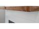 White shiplap fireplace with a rustic wooden mantel and a dark firebox at 6934 Melody Ridge Rd, Buford, GA 30518