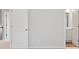 Hallway with white doors, neutral walls, and view to bathroom at 6934 Melody Ridge Rd, Buford, GA 30518