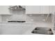 Close up of the kitchen featuring granite countertops, a sink, and subway tile backsplash at 6934 Melody Ridge Rd, Buford, GA 30518