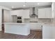 Well-lit kitchen featuring white cabinets, stainless steel appliances, and a large center island at 6934 Melody Ridge Rd, Buford, GA 30518
