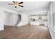 Open concept living room and kitchen featuring wood-look floors and stainless steel appliances at 6934 Melody Ridge Rd, Buford, GA 30518